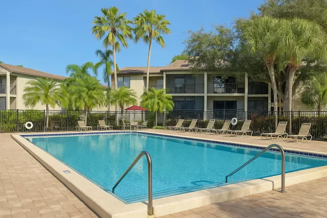a view of a house with swimming pool and sitting area
