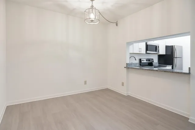a view of a kitchen with a sink and dishwasher a microwave oven