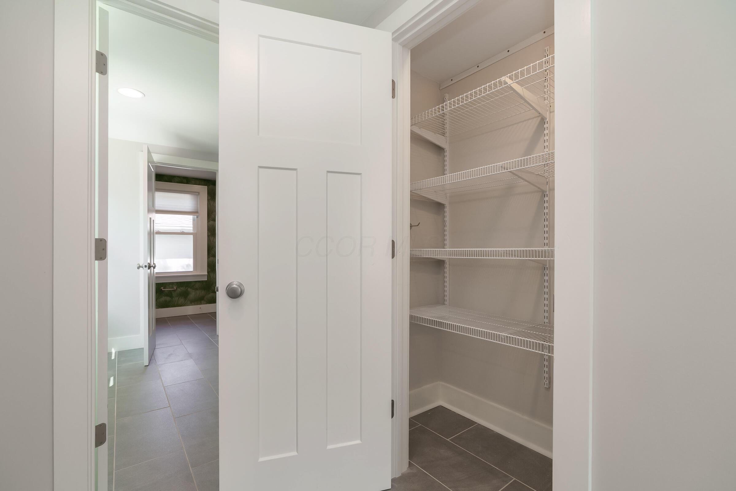 163 Garden Road Columbus, OH 43214 - Photo 19 of 46 Enjoy a large pantry in addition to the abundance of cabinetry in this updated kitchen.