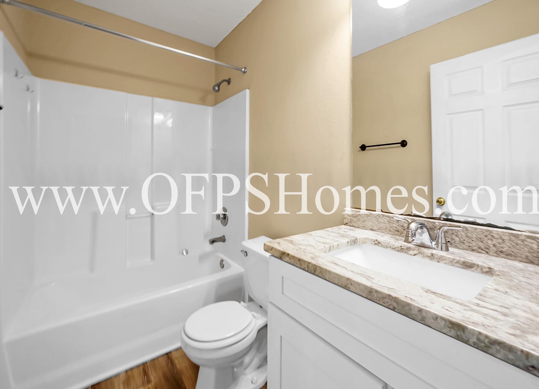 2953 Sholtz Avenue Crestview, FL 32539 - Photo 11 of 33 a bathroom with a granite countertop sink mirror vanity and toilet