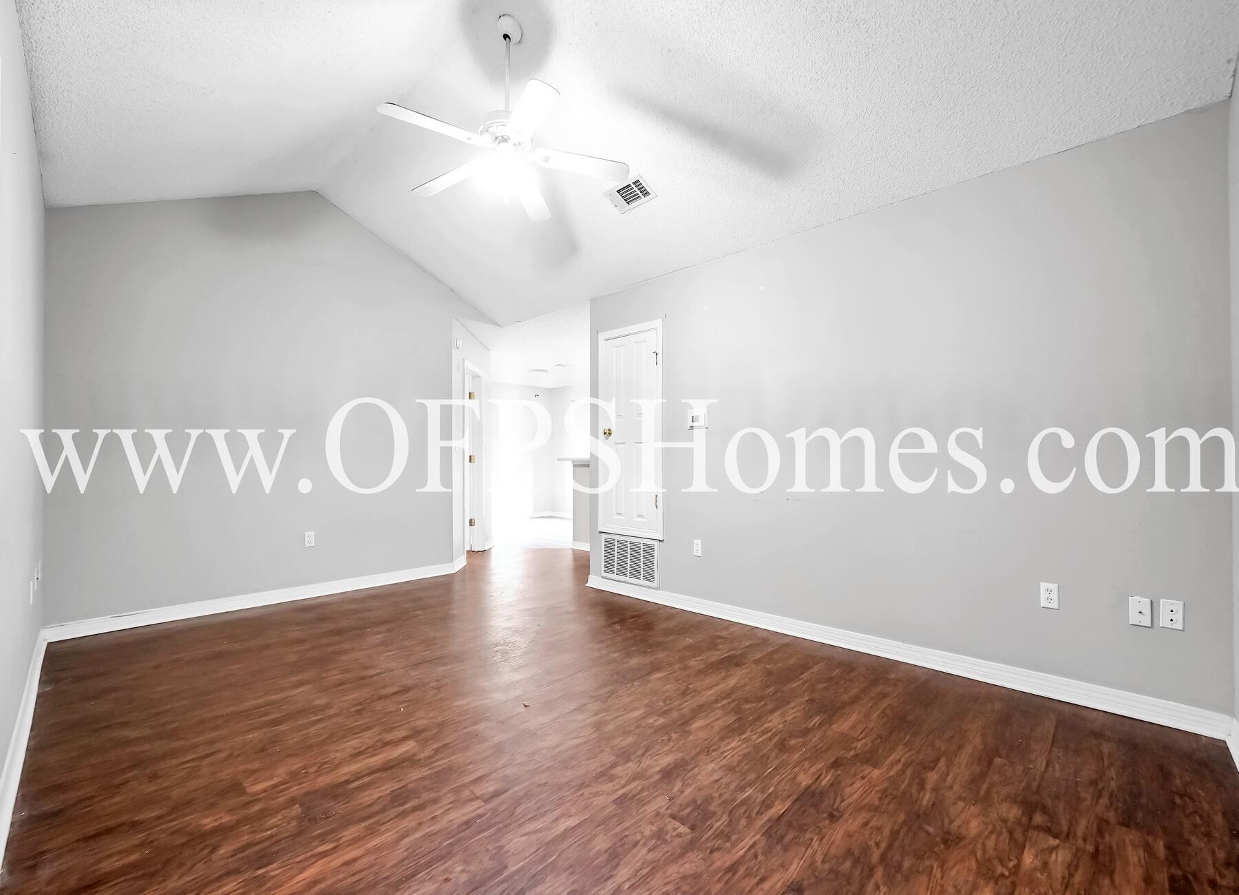 2953 Sholtz Avenue Crestview, FL 32539 - Photo 12 of 33 a view of an empty room with wooden floor