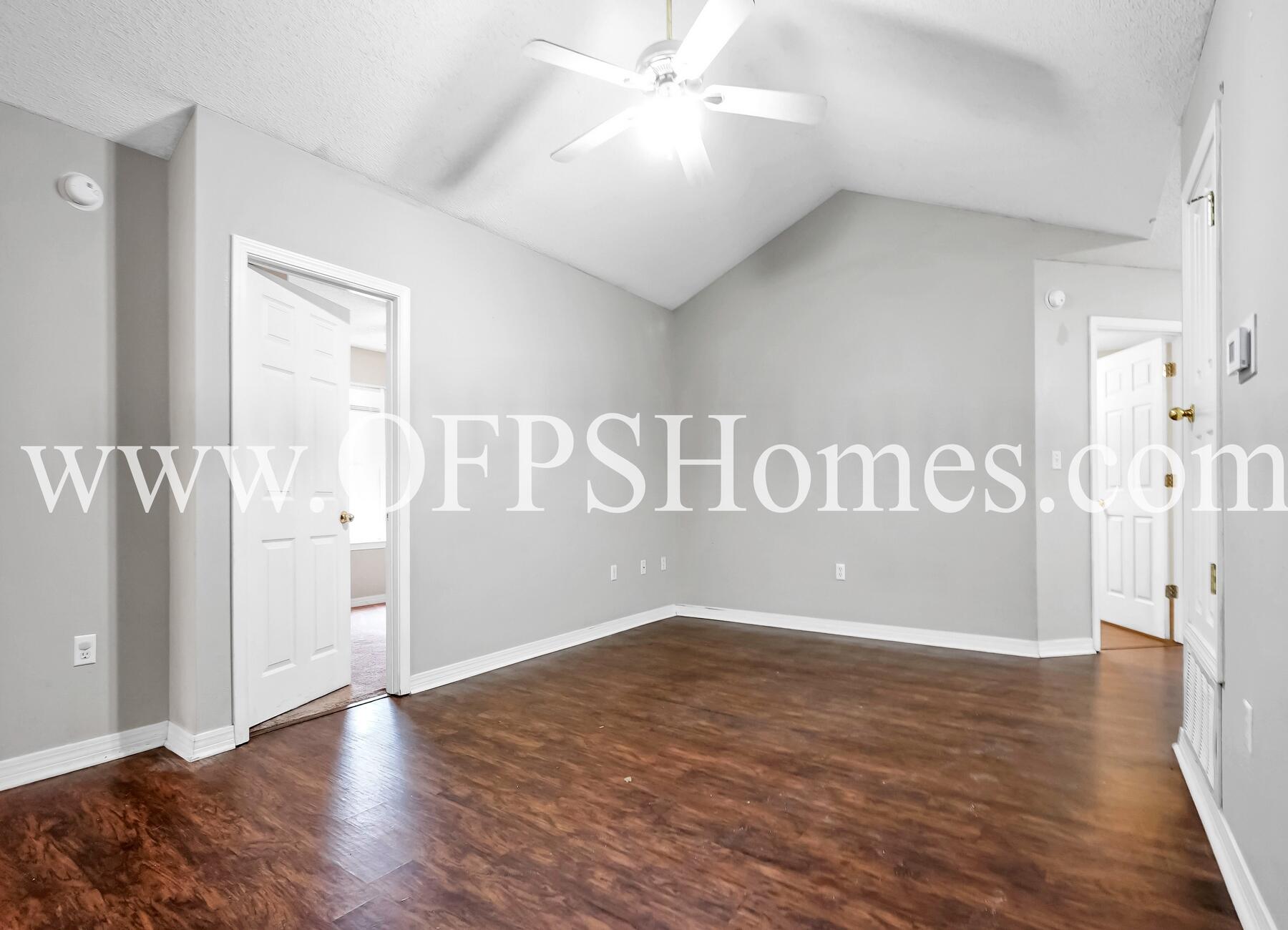 2953 Sholtz Avenue Crestview, FL 32539 - Photo 13 of 33 a view of an empty room with wooden floor