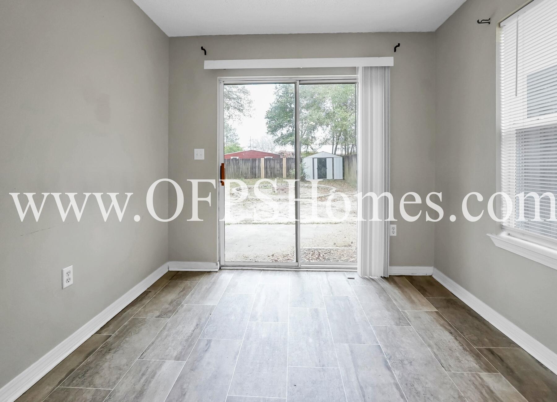 2953 Sholtz Avenue Crestview, FL 32539 - Photo 19 of 33 a view of a room with wooden floor and windows