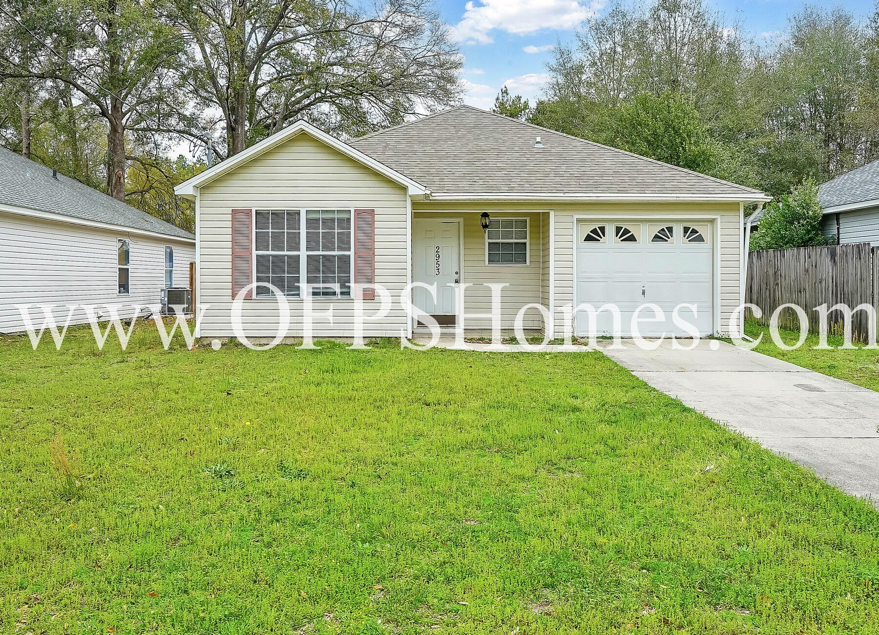 2953 Sholtz Avenue Crestview, FL 32539 - Photo 2 of 33 a front view of a house with garden and porch