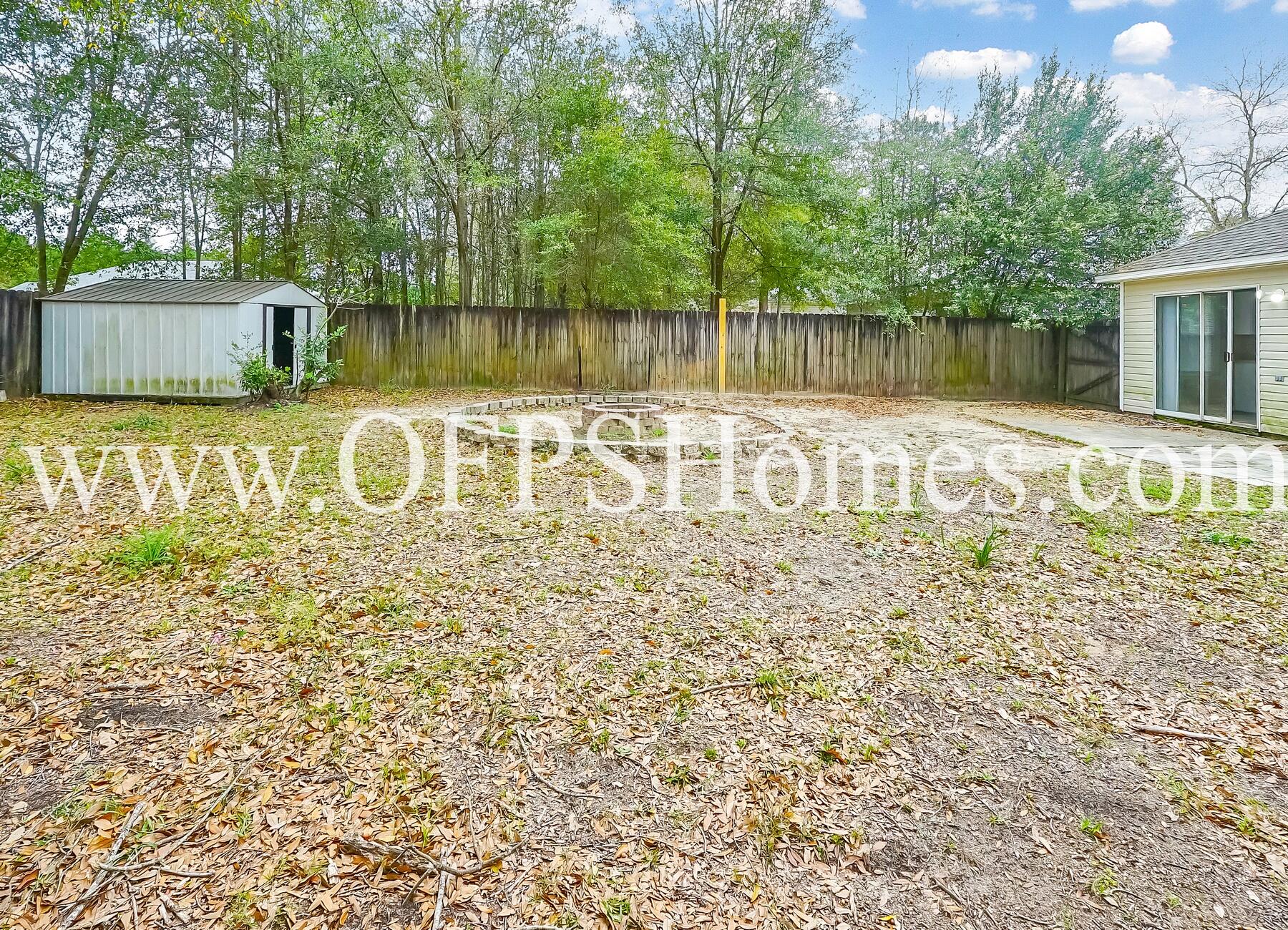 2953 Sholtz Avenue Crestview, FL 32539 - Photo 29 of 33 a view of a back yard with a table and a chair