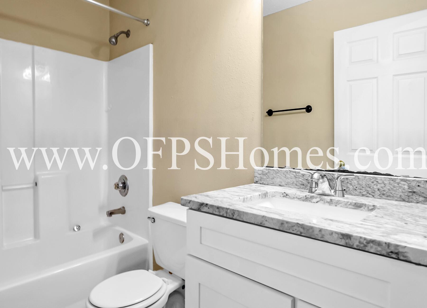 2953 Sholtz Avenue Crestview, FL 32539 - Photo 6 of 33 a bathroom with a granite countertop sink and a mirror