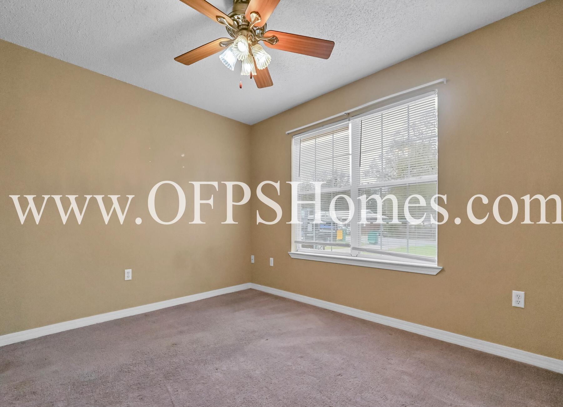 2953 Sholtz Avenue Crestview, FL 32539 - Photo 8 of 33 an empty room with windows and fan