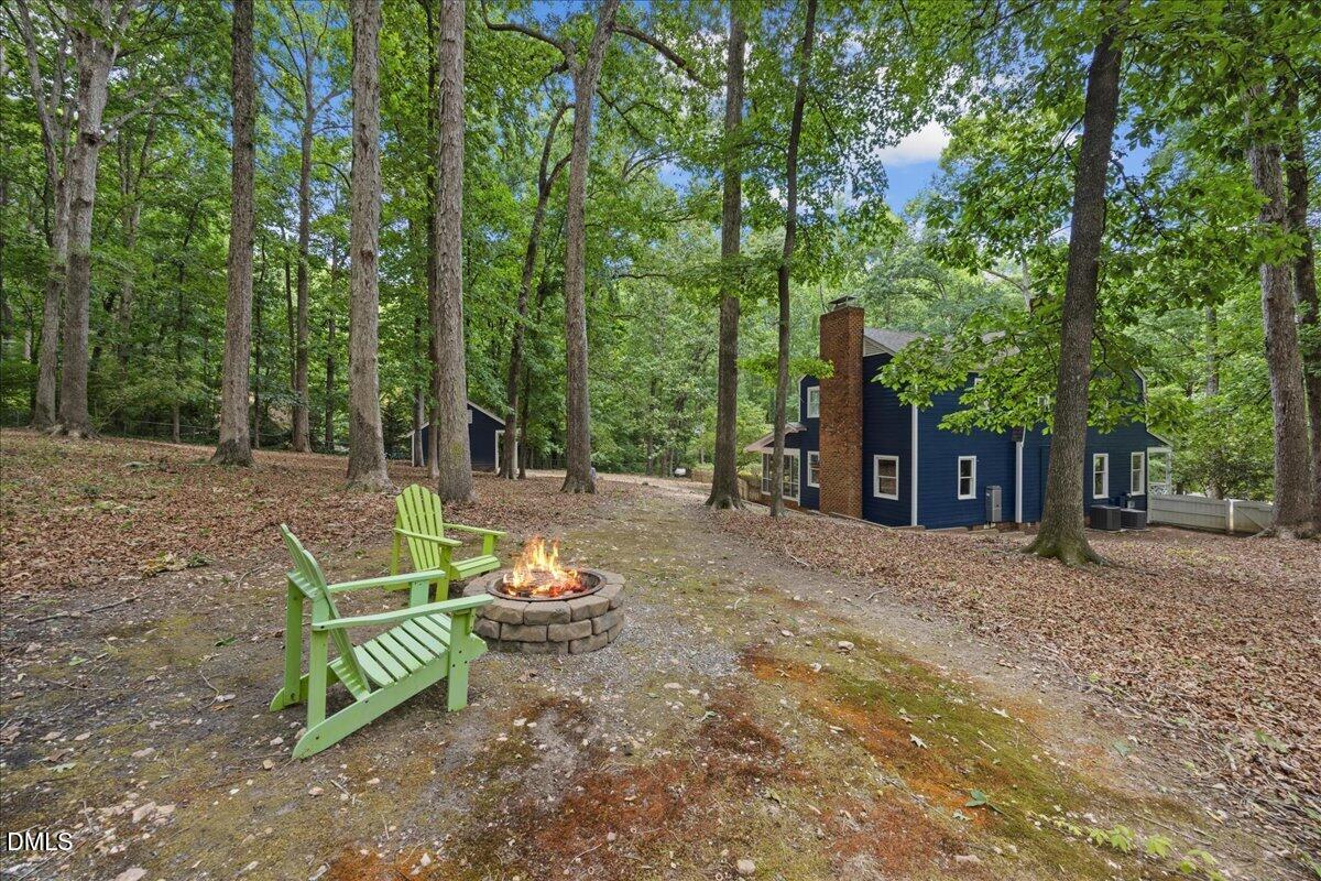6516 Bakersfield Drive Raleigh, NC 27606 - Photo 48 of 59 a view of a chair and tables in the backyard