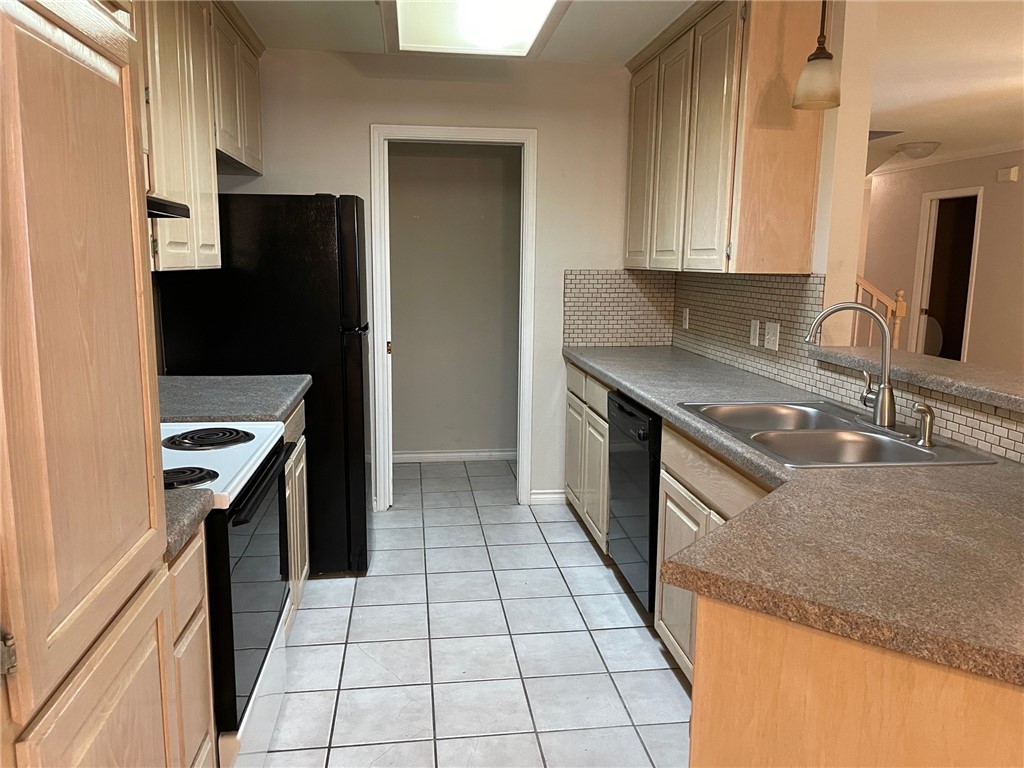 4022 Wood River Drive, Unit 5C Corpus Christi, TX 78410 - Photo 4 of 10 a kitchen with stainless steel appliances granite countertop a refrigerator a stove and a sink