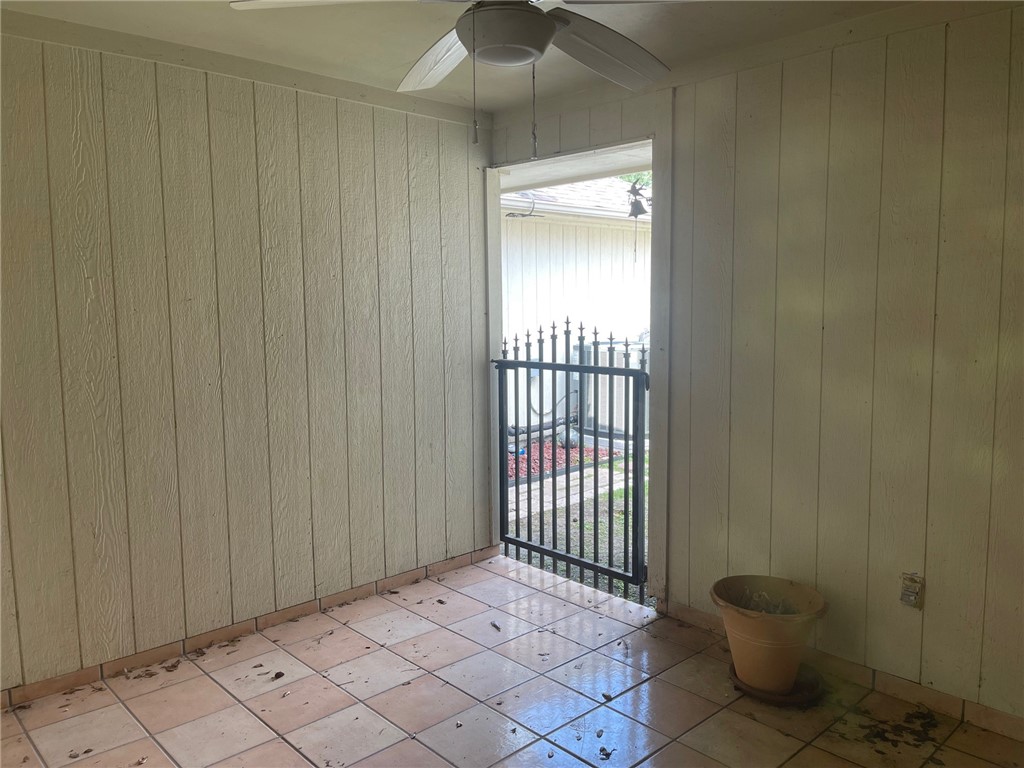 4022 Wood River Drive, Unit 5C Corpus Christi, TX 78410 - Photo 6 of 10 a view of an empty room with a chair