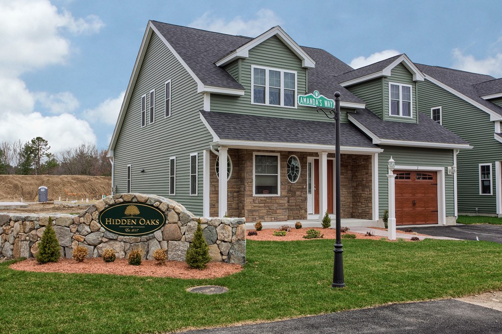 18 Jaclyn's Way, Unit 19 Billerica, MA 01821 - Photo 1 of 16 a front view of a house with garden