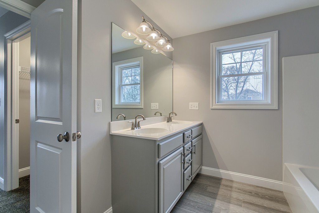 18 Jaclyn's Way, Unit 19 Billerica, MA 01821 - Photo 14 of 16 a bathroom with a double vanity sink a and mirror