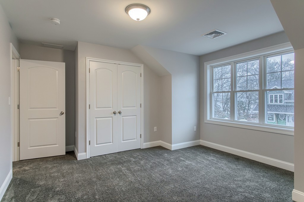 18 Jaclyn's Way, Unit 19 Billerica, MA 01821 - Photo 15 of 16 an empty room with windows