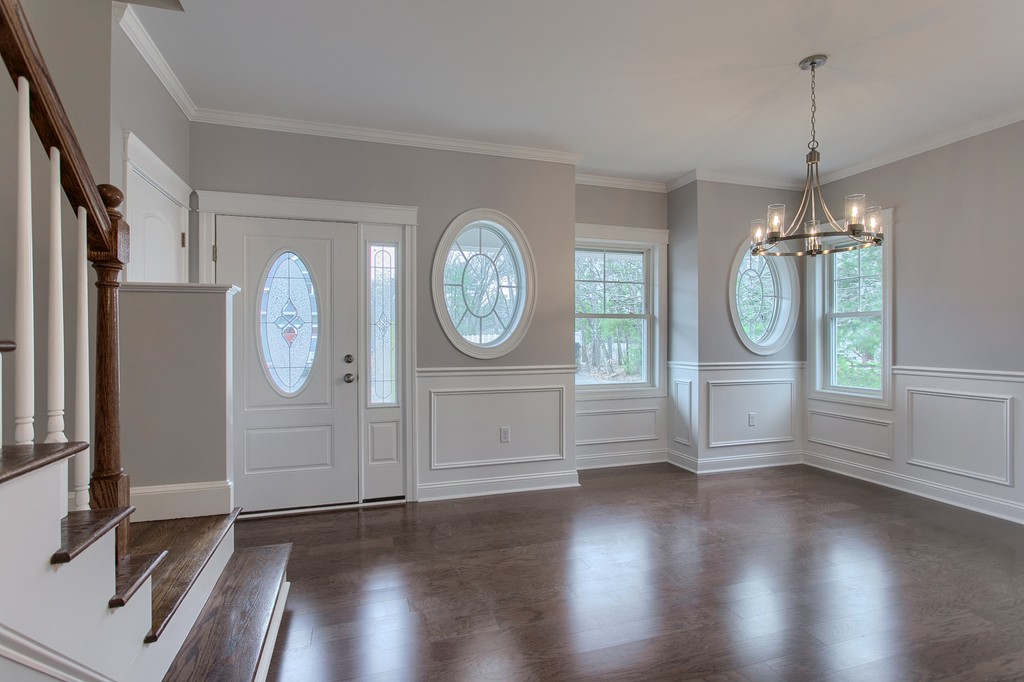 18 Jaclyn's Way, Unit 19 Billerica, MA 01821 - Photo 2 of 16 a view of a room with wooden floor clock and a window