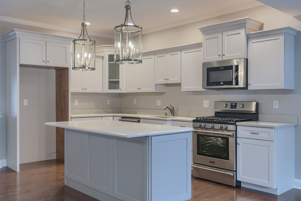 18 Jaclyn's Way, Unit 19 Billerica, MA 01821 - Photo 3 of 16 a kitchen with stainless steel appliances granite countertop a stove and a sink
