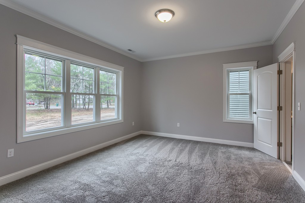 18 Jaclyn's Way, Unit 19 Billerica, MA 01821 - Photo 5 of 16 an empty room with windows