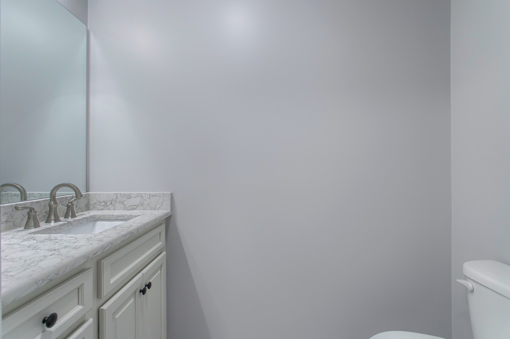 18 Jaclyn's Way, Unit 19 Billerica, MA 01821 - Photo 8 of 16 a bathroom with a granite countertop sink and vanity