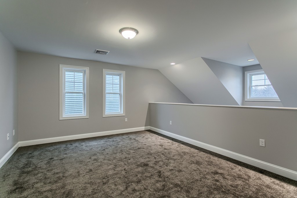 18 Jaclyn's Way, Unit 19 Billerica, MA 01821 - Photo 9 of 16 an empty room with windows