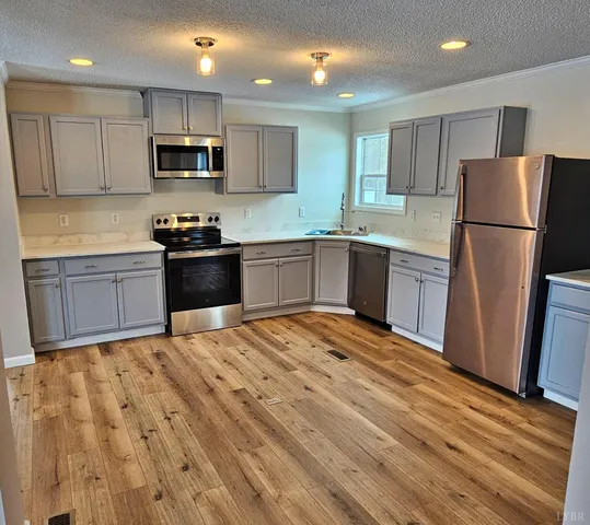 a view of a livingroom with wooden floor and a window
