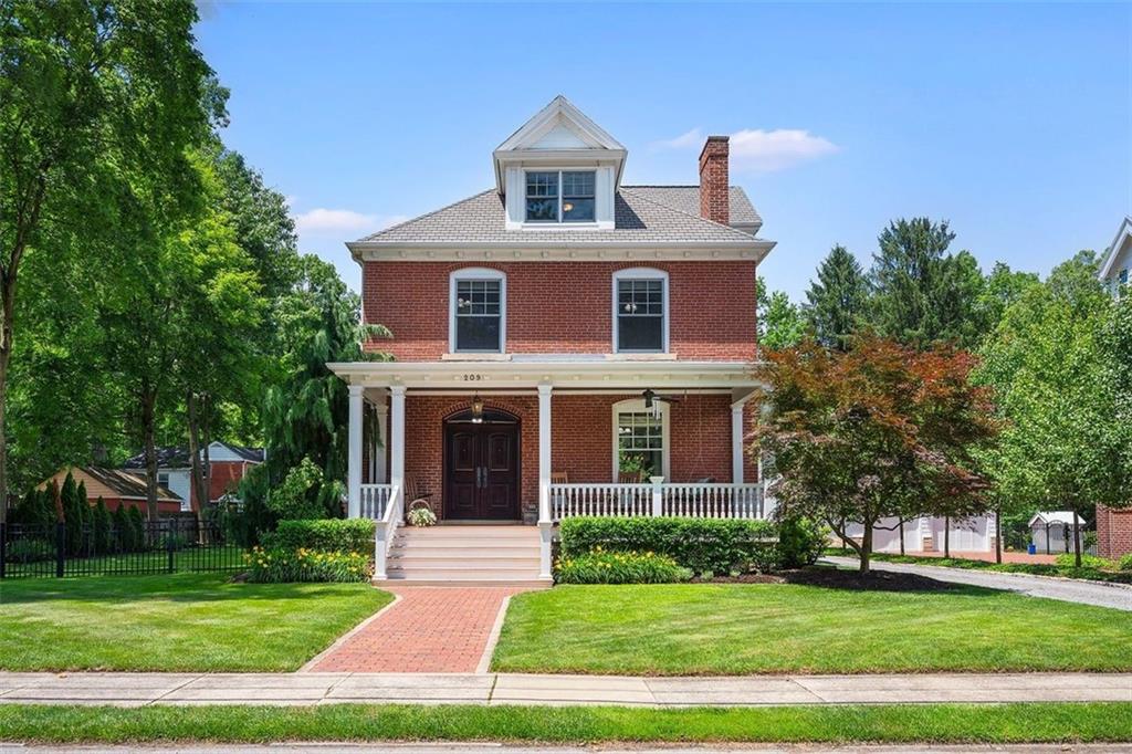 209 Chestnut Road Sewickley, PA 15143 - Photo 1 of 49 a front view of a house with a garden
