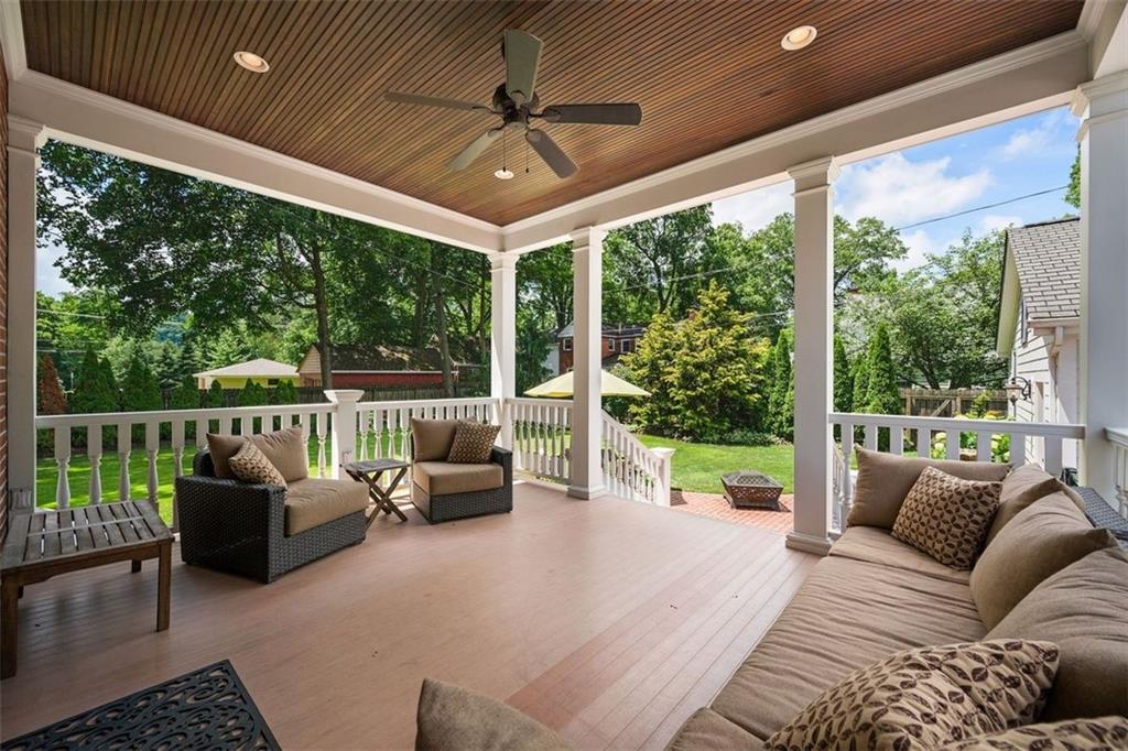 209 Chestnut Road Sewickley, PA 15143 - Photo 13 of 49 a view of a patio with couches chairs potted plants and a floor to ceiling window