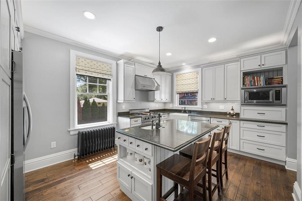 209 Chestnut Road Sewickley, PA 15143 - Photo 26 of 49 a kitchen with a table chairs refrigerator and microwave