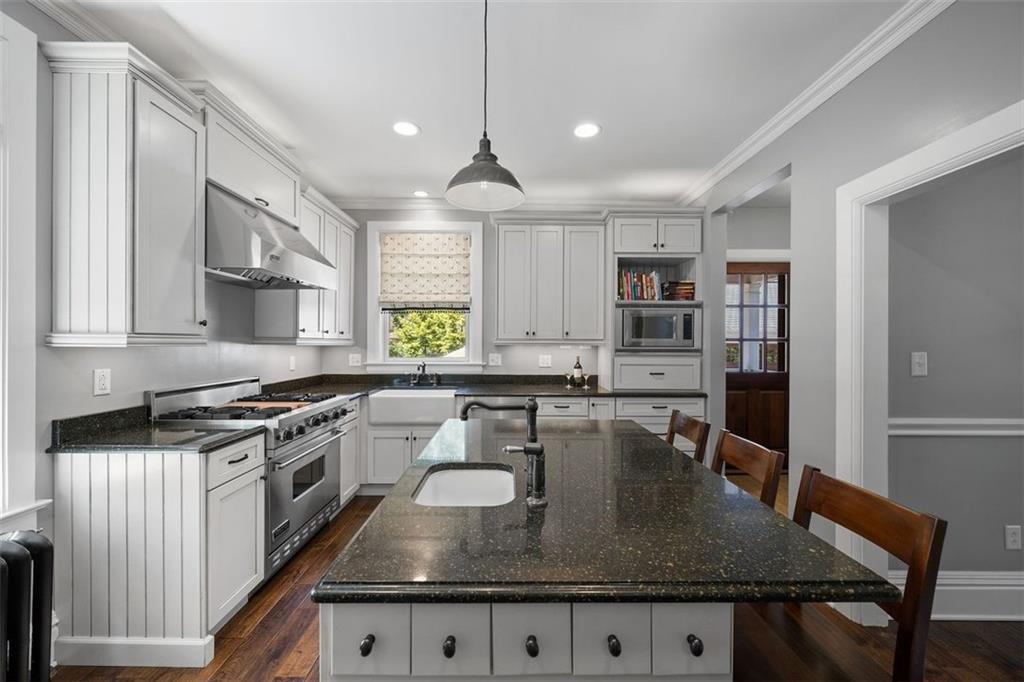 209 Chestnut Road Sewickley, PA 15143 - Photo 27 of 49 a kitchen with granite countertop a stove a sink a refrigerator dining table and chairs