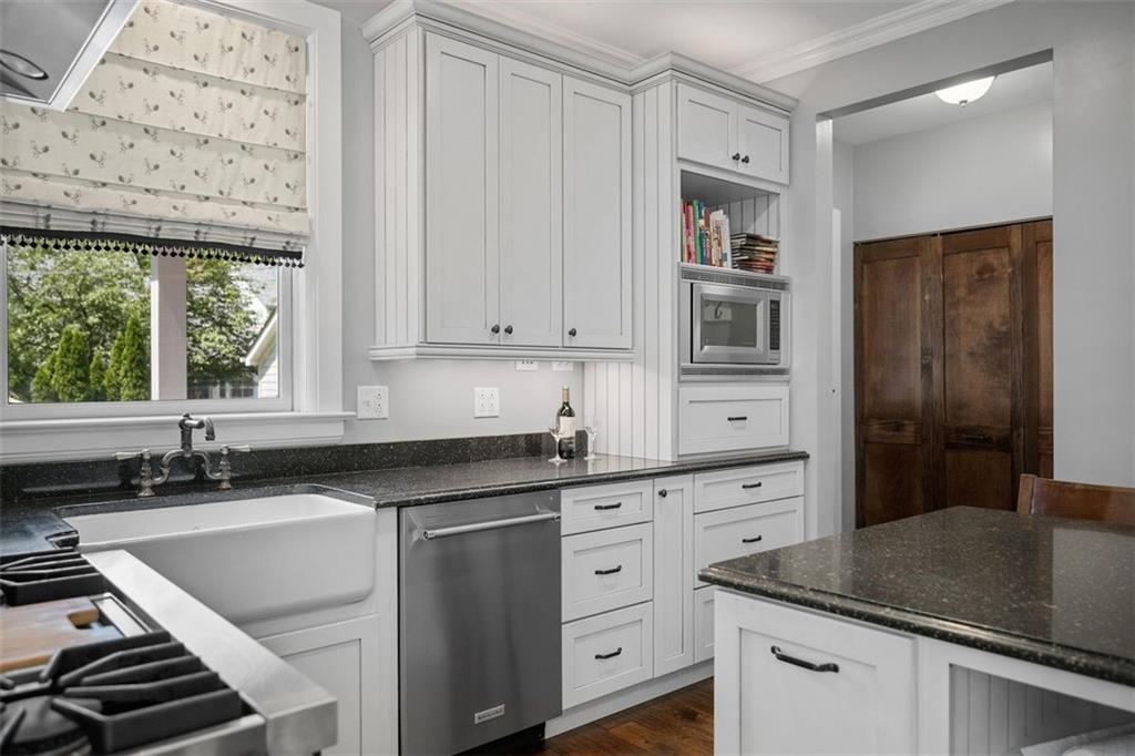 209 Chestnut Road Sewickley, PA 15143 - Photo 30 of 49 a kitchen with stainless steel appliances granite countertop a sink and cabinets with wooden floor
