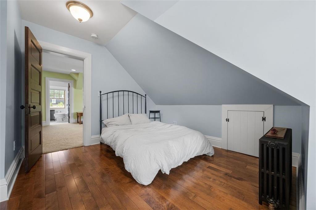 209 Chestnut Road Sewickley, PA 15143 - Photo 47 of 49 a bedroom with a bed and wooden floor