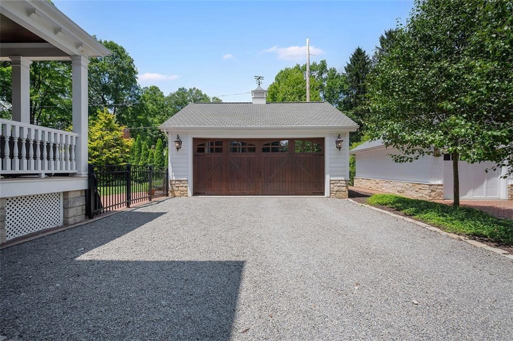 209 Chestnut Road Sewickley, PA 15143 - Photo 5 of 49 a front view of a house with a yard and garage