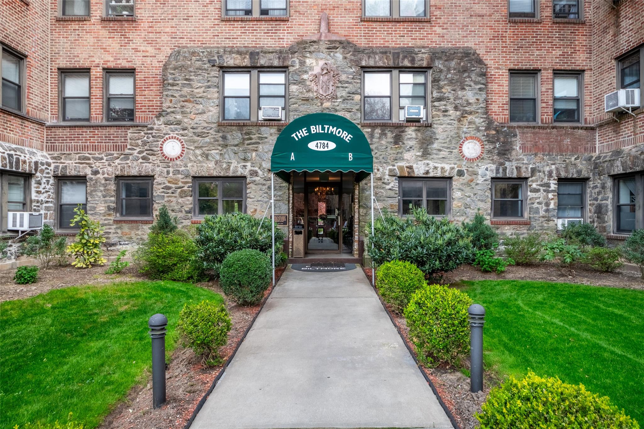 4784 Boston Post Road, Unit A45 Pelham, NY 10803 - Photo 1 of 1 a house view with a garden space