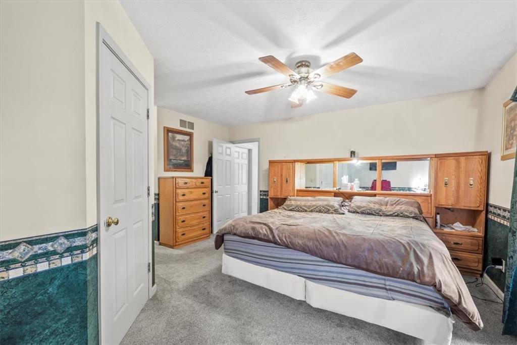 0 Grange Road Beaver Falls, PA 15010 - Photo 31 of 50 a bedroom with a bed and a chandelier