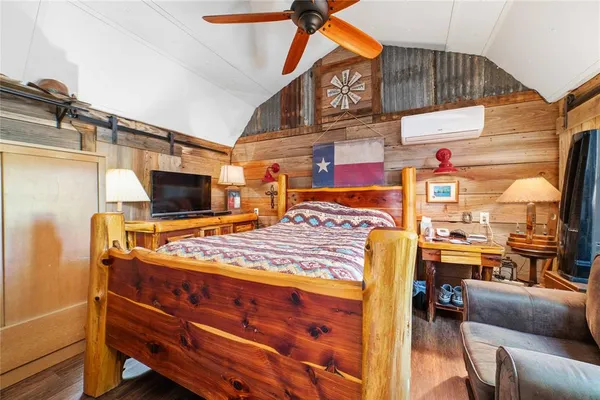 a bed room with a bed and a television