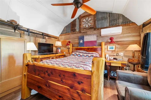 a bed room with a bed and a television