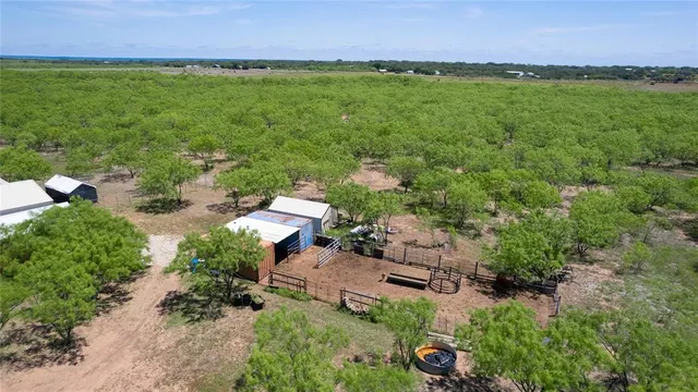 an aerial view of a houses with a yard and lake view