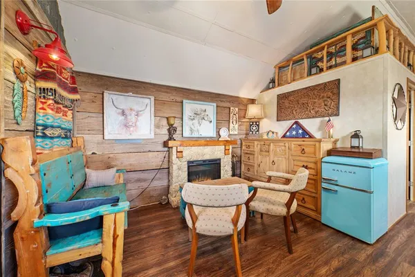 a dining room with furniture a rug and wooden floor