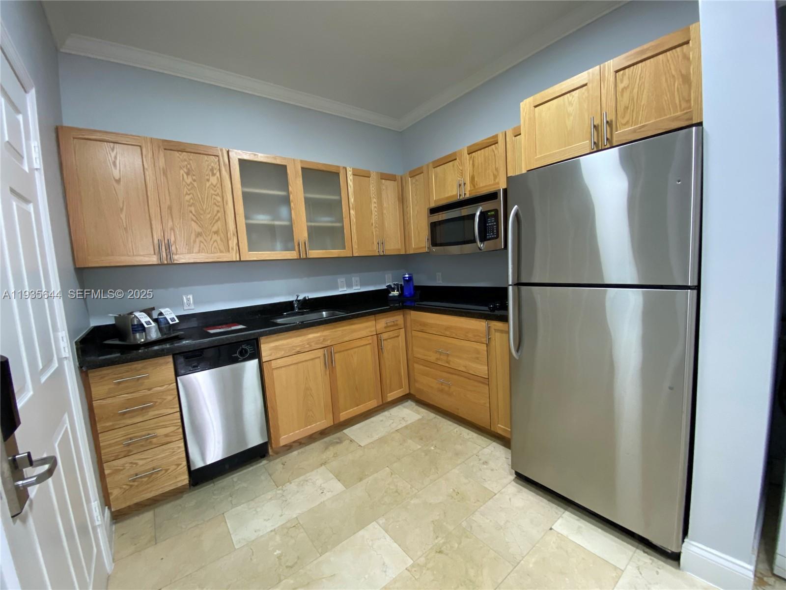 1750 Northwest 107th Avenue, Unit R509 Sweetwater, FL 33172 - Photo 8 of 23 a kitchen with stainless steel appliances granite countertop a refrigerator a sink and a stove