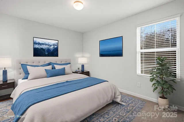 a bedroom with bed and a potted plant
