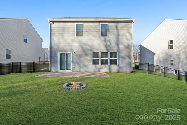 a backyard of a house with table and chairs