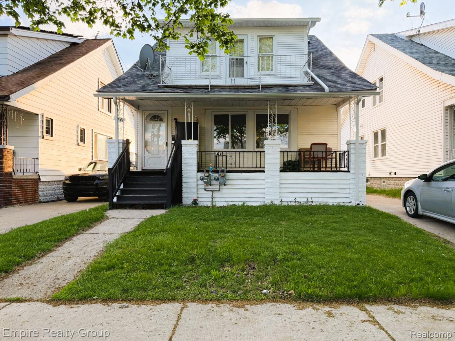 6441 Appoline Street, Unit 1 Dearborn, MI 48126 - Photo 1 of 13 View of front of house with a porch, roof with shingles, a front lawn, and a balcony