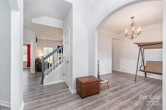 a living room with wooden floor and stairs