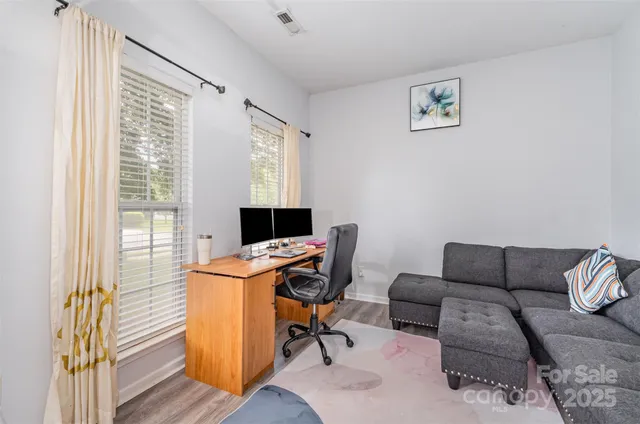 a livingroom with workspace and a couch