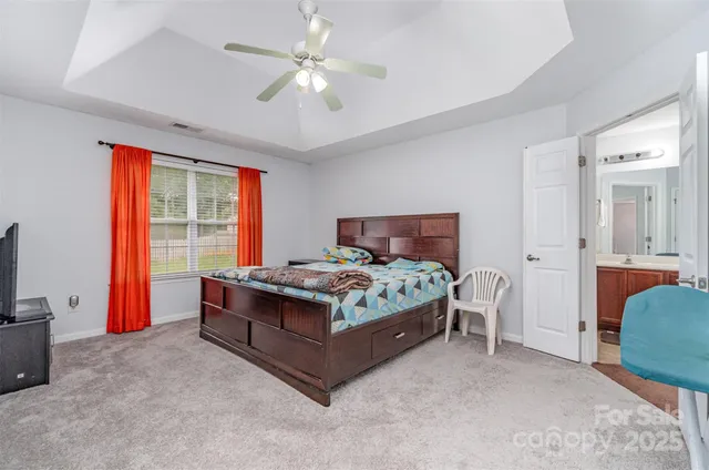 a bedroom with a bed and a television