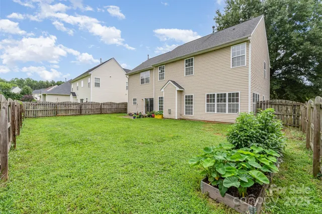 a view of a house with a yard and sitting area