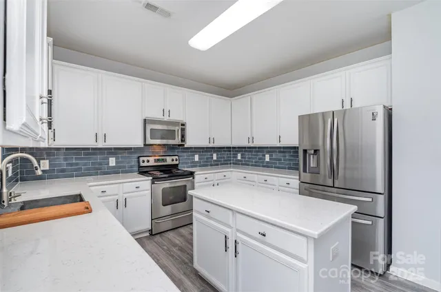 a kitchen with a sink a stove and refrigerator