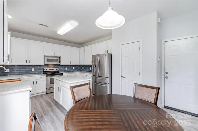 a kitchen with a refrigerator a stove top oven a sink and dishwasher