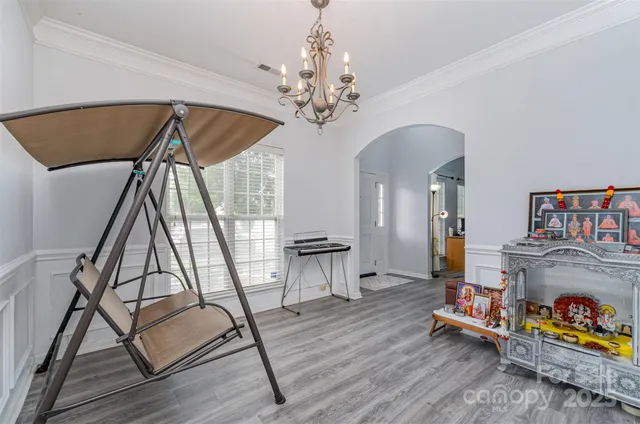 a view of hall way with furniture and chandelier