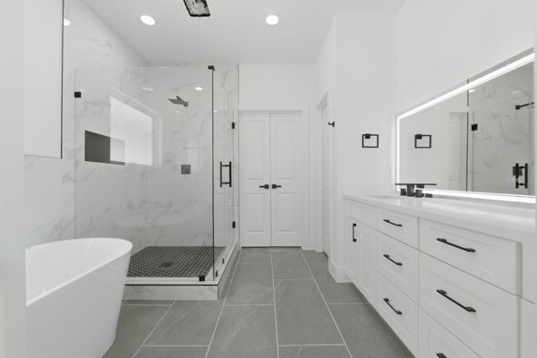 6539 Sealey Street Houston, TX 77091 - Photo 20 of 28 a bathroom with a granite countertop sink a toilet a mirror and shower