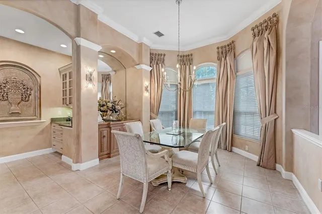 a kitchen with a sink a refrigerator and chandelier