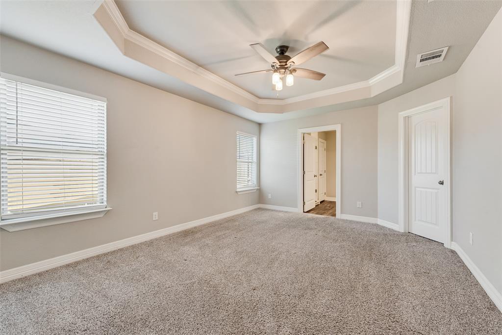 625 Copenhavr Street Pilot Point, TX 76258 - Photo 12 of 20 Unfurnished bedroom featuring a raised ceiling, crown molding, carpet floors, and ceiling fan